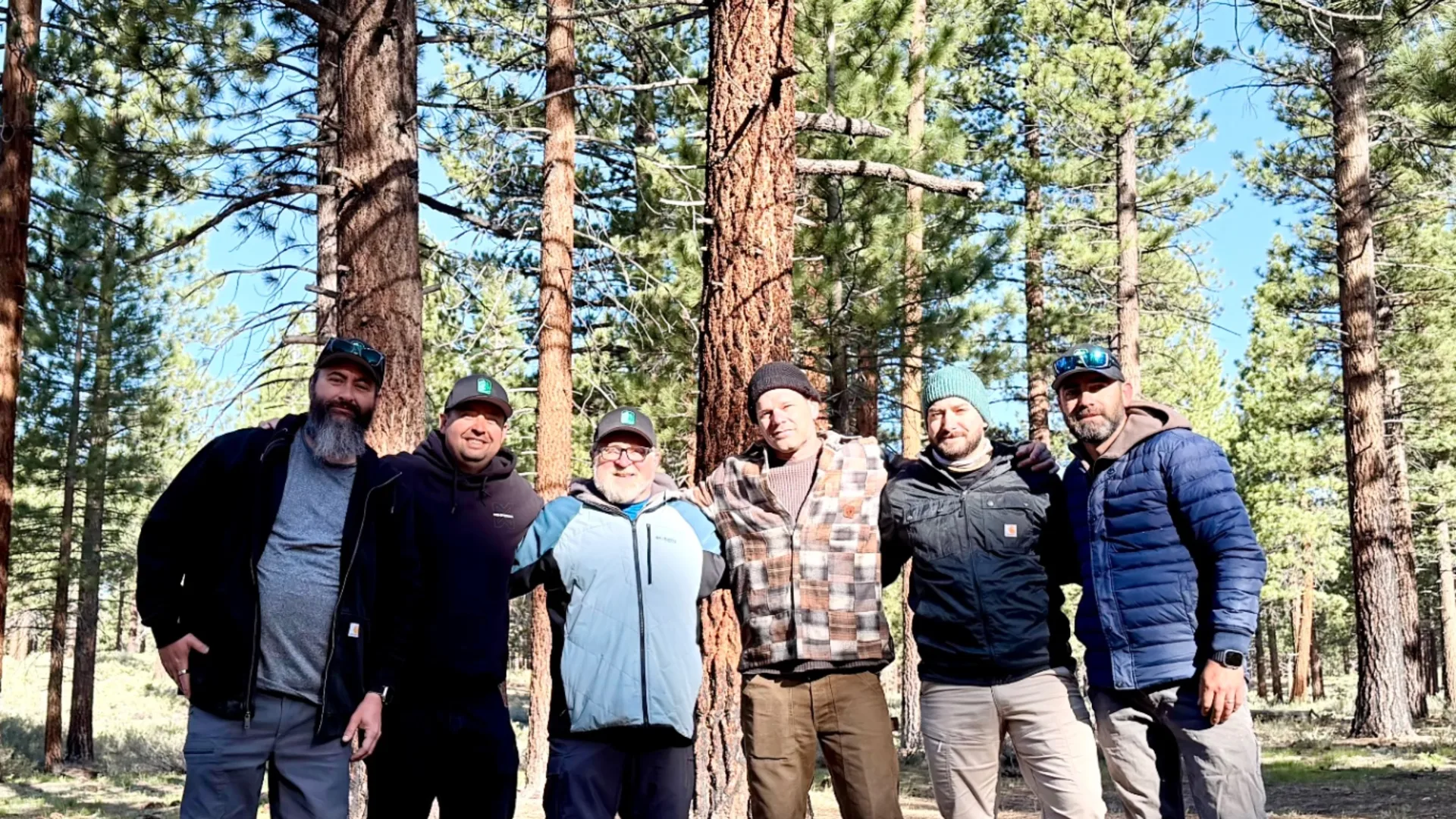 Group of men together in the Eastern Sierra pines